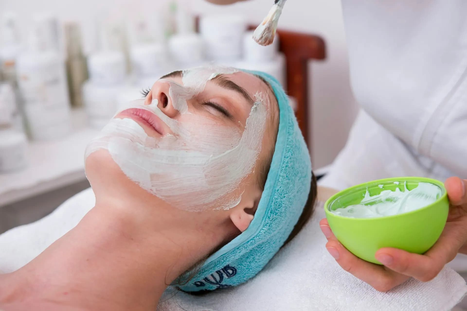 Clay mask being applied during a facial